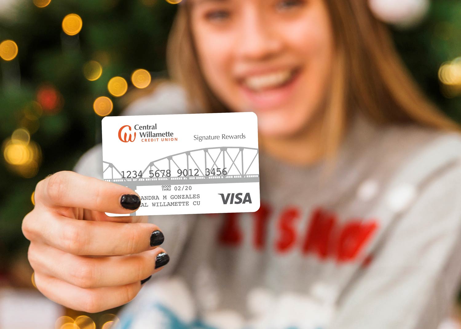 Woman showing off her Central Willamette Credit Union Credit Card 